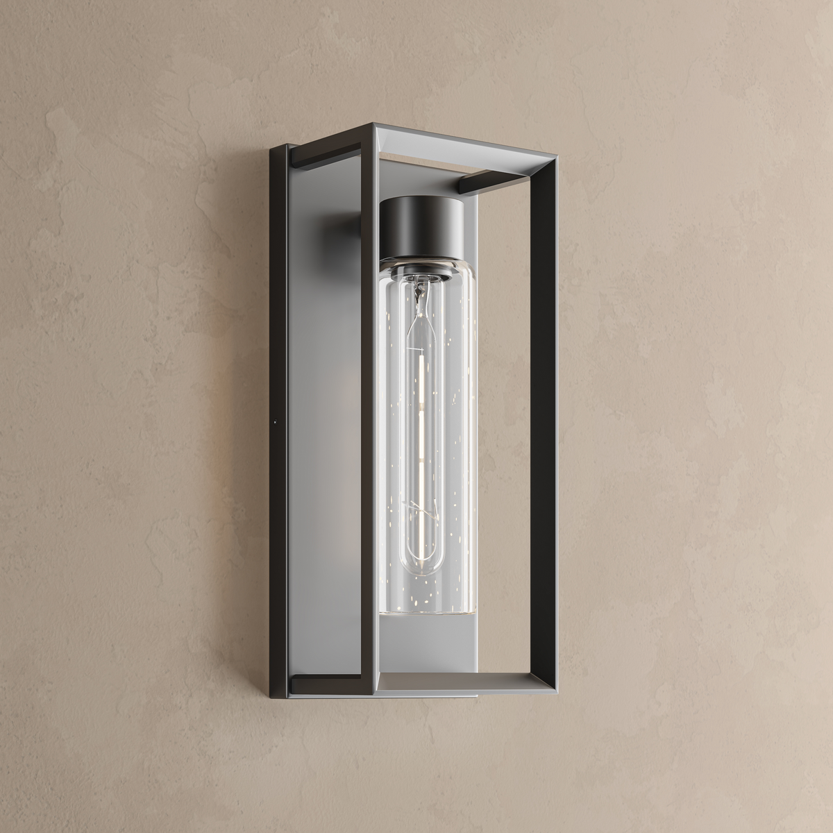 Applique murale extérieure noire, cadre rectangulaire ouvert en inox et cylindre de verre texturé avec ampoule LED T10, sur un mur enduit beige