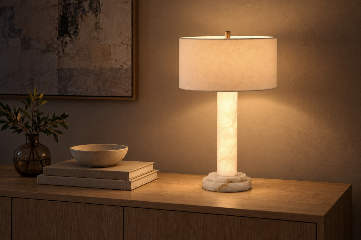 Lilio Drum Calcite table lamp in a living room at night, lit (AI-generated scene)