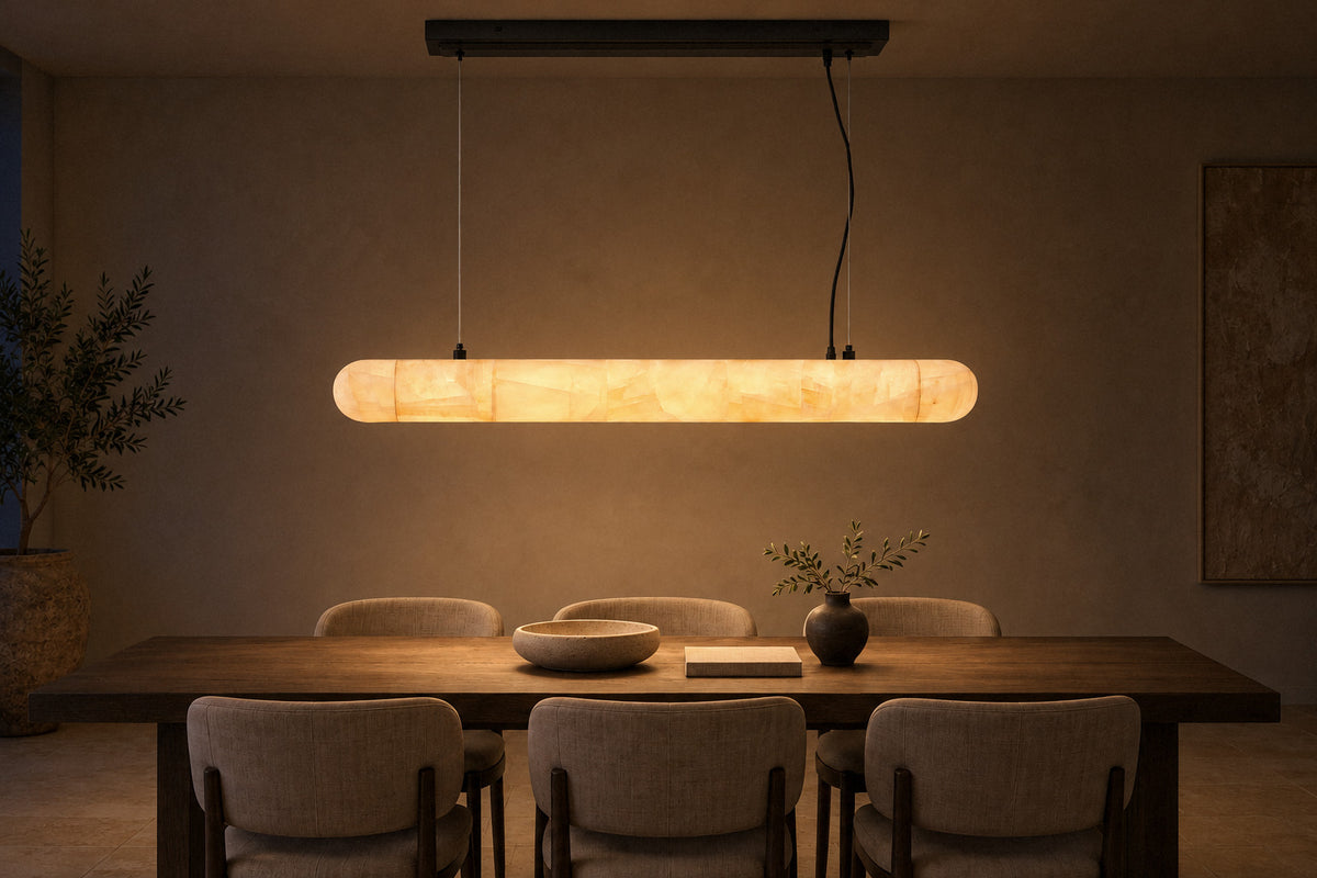 Lilio Linear Calcite Chandelier stone pendant in a dining room at night, lit (AI-generated scene)