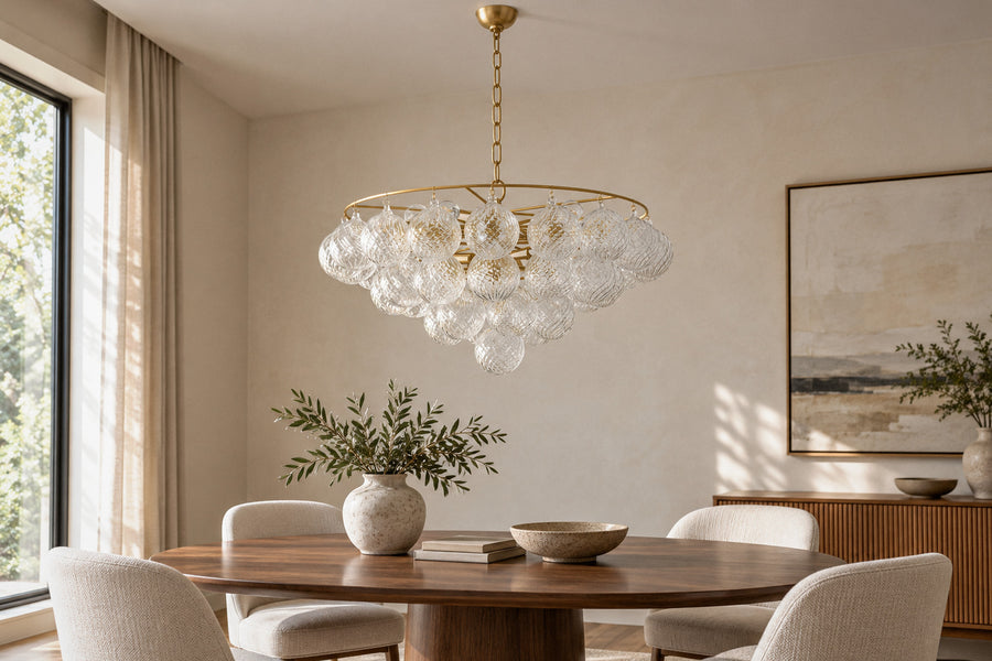 Mimi glass and gold metal chandelier in a dining room by day, switched off (AI-generated scene)